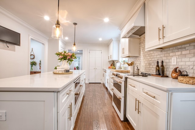 kitchen with premium range hood, double oven range, light countertops, and ornamental molding