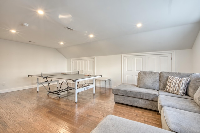 recreation room with recessed lighting, visible vents, vaulted ceiling, wood finished floors, and baseboards