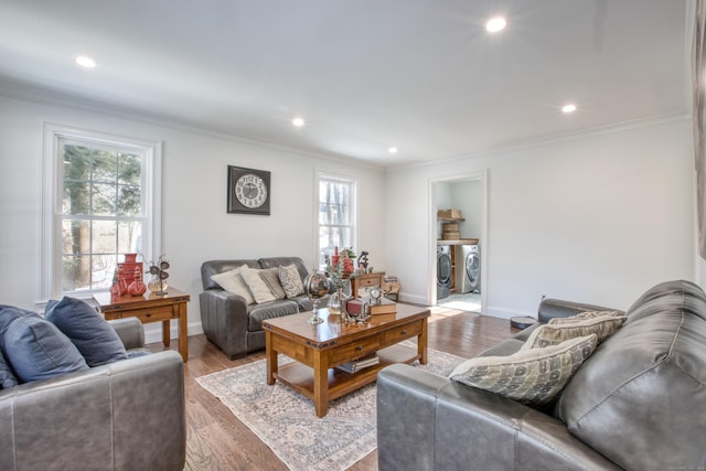 living area with baseboards, ornamental molding, wood finished floors, washer and dryer, and recessed lighting