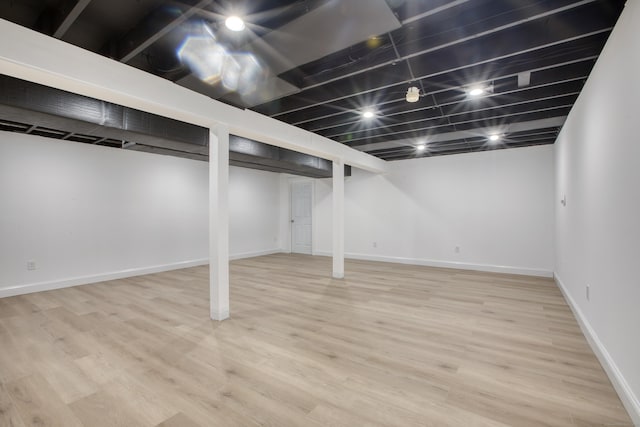 finished basement featuring baseboards and wood finished floors