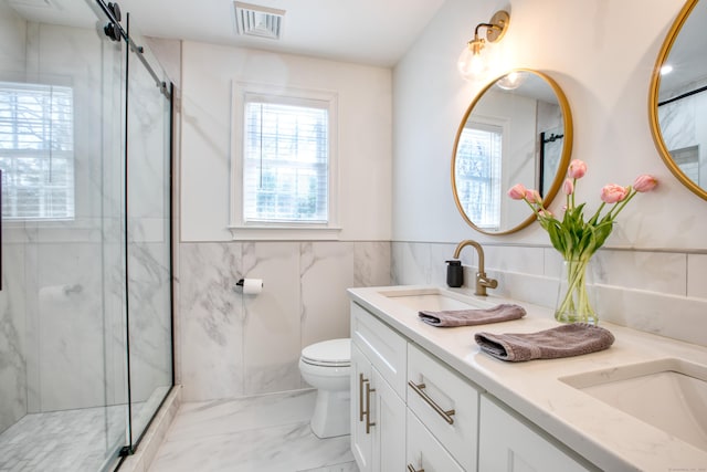 full bath featuring a wealth of natural light, marble finish floor, and a sink