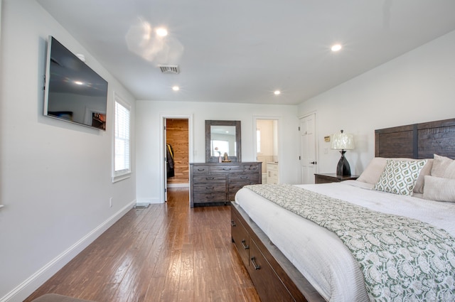 bedroom featuring a walk in closet, dark wood-style flooring, recessed lighting, visible vents, and baseboards