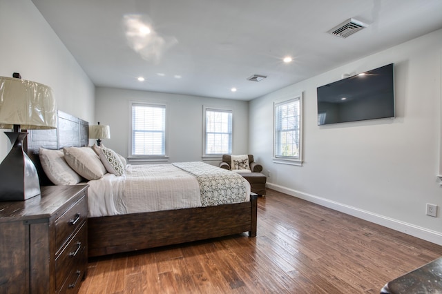 bedroom featuring baseboards, visible vents, wood finished floors, and recessed lighting