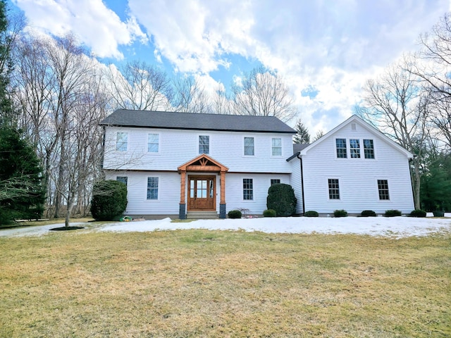 colonial-style house with a front lawn