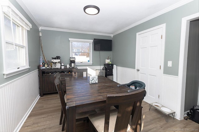 dining space featuring hardwood / wood-style flooring and ornamental molding