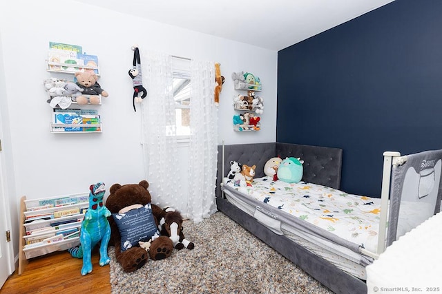 bedroom with hardwood / wood-style floors