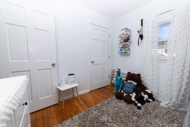 bedroom with hardwood / wood-style flooring