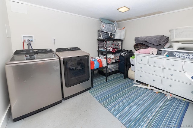 clothes washing area with washing machine and dryer and ornamental molding