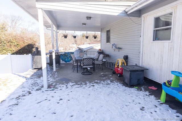 snow covered patio featuring grilling area