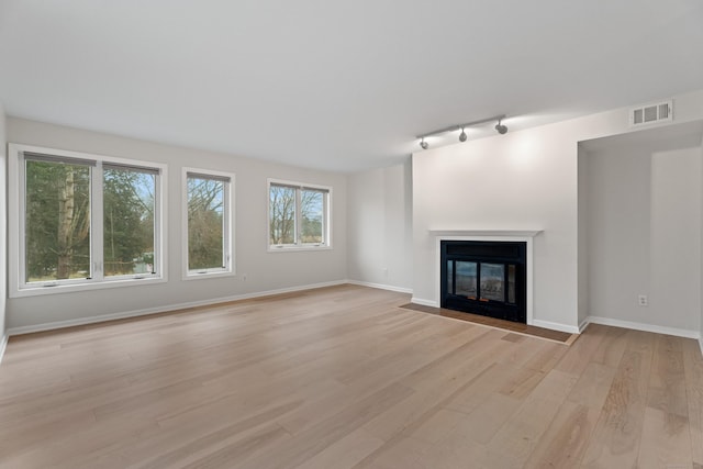 80 Seaview Ter Unit 12, Guilford, CT 06437 - unfurnished living room with a fireplace with flush hearth, light wood finished floors, track lighting, and baseboards