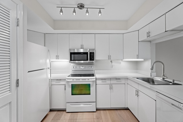 80 Seaview Ter Unit 12, Guilford, CT 06437 - kitchen with white appliances, a sink, light countertops, white cabinetry, and light wood-style floors