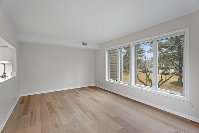 unfurnished room featuring light hardwood / wood-style floors