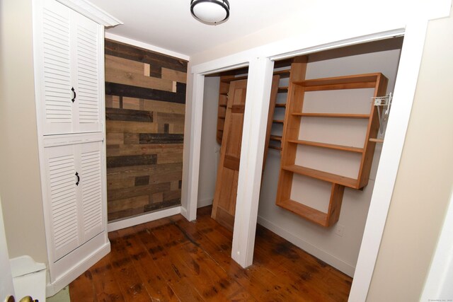 34 Lyme St, Old Lyme, CT 06371 - hall with dark wood-style floors, wood walls, and baseboards