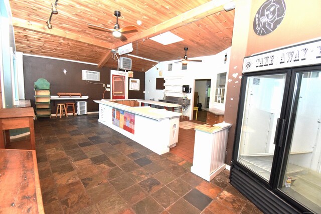 34 Lyme St, Old Lyme, CT 06371 - kitchen with a ceiling fan, wooden ceiling, a center island, dark stone finish flooring, and a wall mounted air conditioner