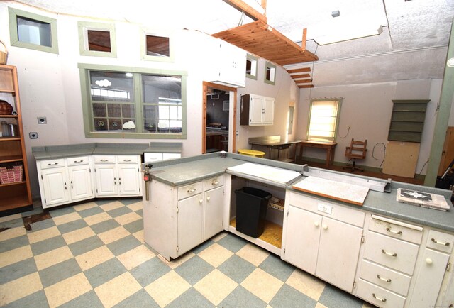 34 Lyme St, Old Lyme, CT 06371 - kitchen with light flooring, white cabinetry, and an office area