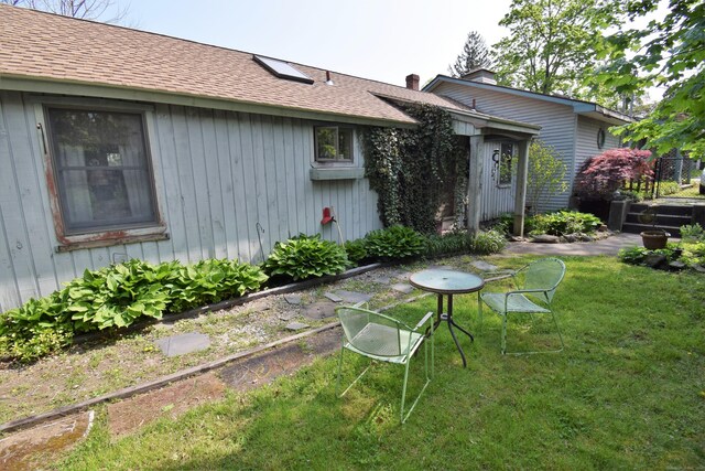 34 Lyme St, Old Lyme, CT 06371 - rear view of property featuring a yard and a shingled roof