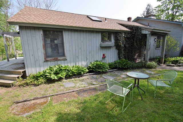 34 Lyme St, Old Lyme, CT 06371 - back of house featuring a deck, roof with shingles, and a lawn