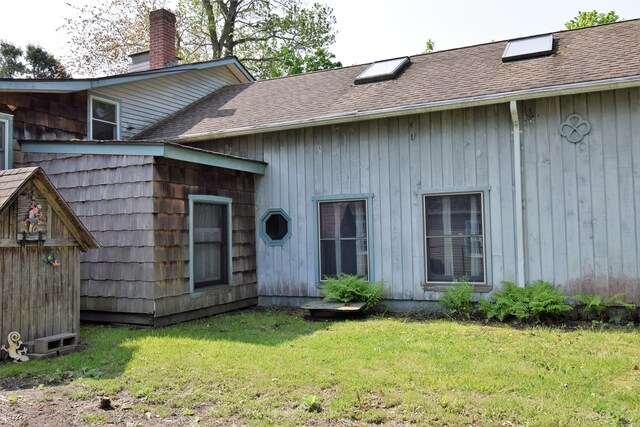 34 Lyme St, Old Lyme, CT 06371 - back of property with a chimney, a yard, and a shingled roof