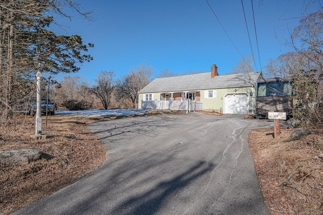 view of front of house with a porch and a garage