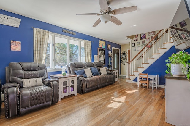 living room with ceiling fan and light wood-type flooring