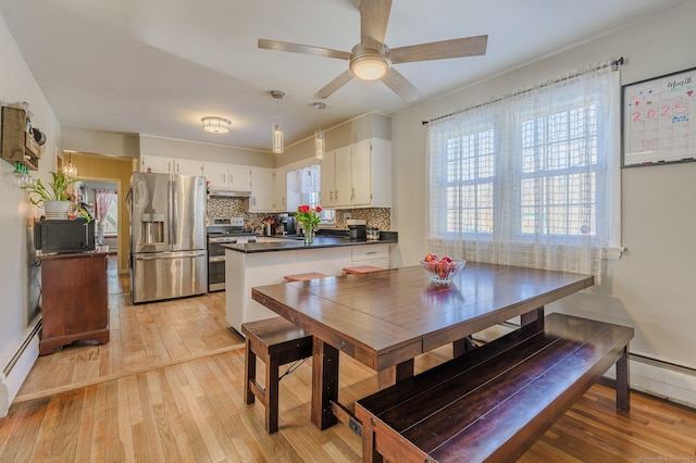 dining area with ceiling fan, light hardwood / wood-style flooring, and a baseboard radiator