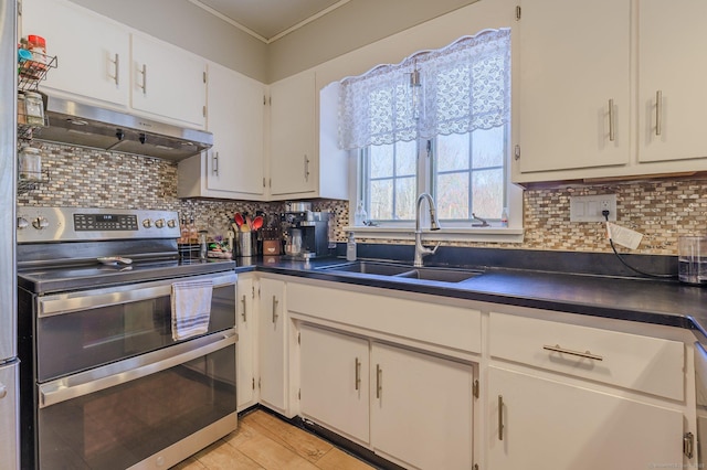 kitchen with double oven range, sink, decorative backsplash, and white cabinets