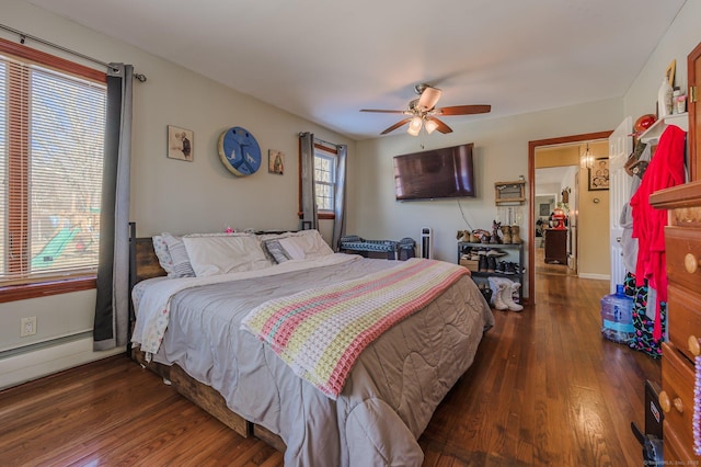 bedroom with ceiling fan and dark hardwood / wood-style flooring