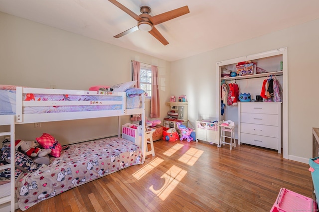 bedroom featuring ceiling fan, dark hardwood / wood-style flooring, and a closet