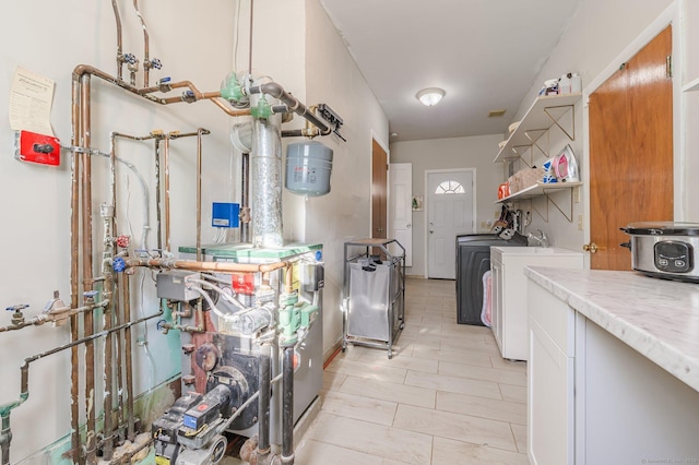 kitchen featuring white cabinetry and washer and dryer