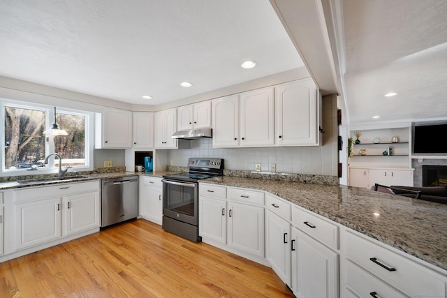 kitchen featuring white cabinetry, appliances with stainless steel finishes, sink, and light hardwood / wood-style floors