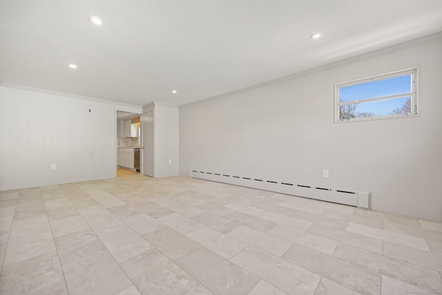 spare room featuring ornamental molding and baseboard heating