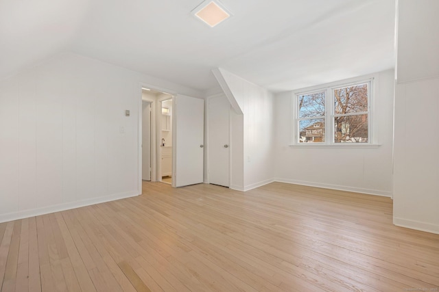 bonus room with lofted ceiling and light hardwood / wood-style floors