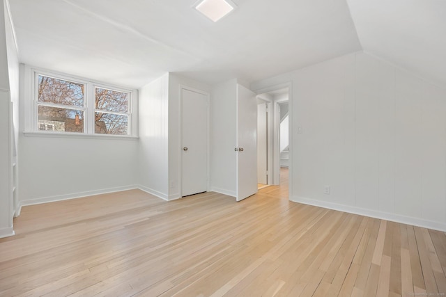 bonus room with vaulted ceiling and light hardwood / wood-style floors