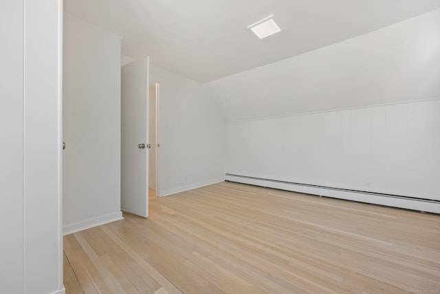 bonus room with baseboard heating, lofted ceiling, and light hardwood / wood-style floors