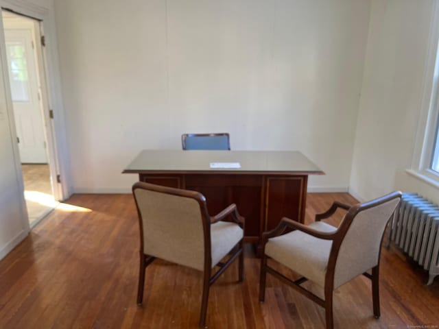 office featuring radiator and hardwood / wood-style flooring