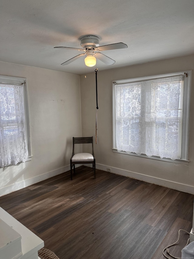 unfurnished room featuring dark hardwood / wood-style flooring, plenty of natural light, and ceiling fan