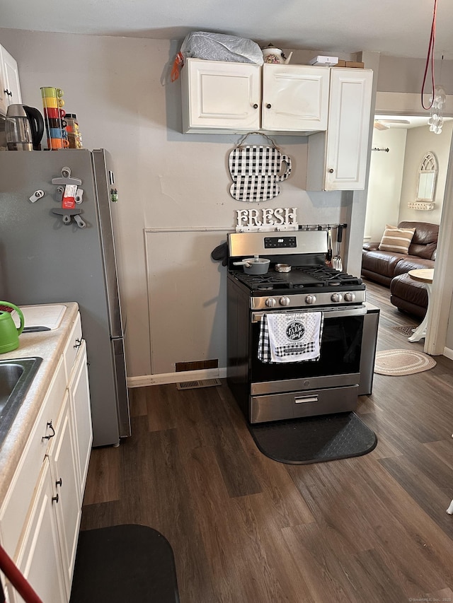 kitchen featuring white cabinetry, appliances with stainless steel finishes, and dark hardwood / wood-style floors