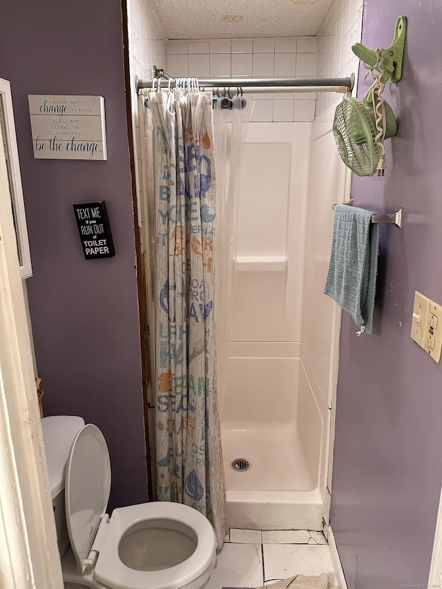 bathroom with tile patterned flooring, toilet, a textured ceiling, and a shower with shower curtain