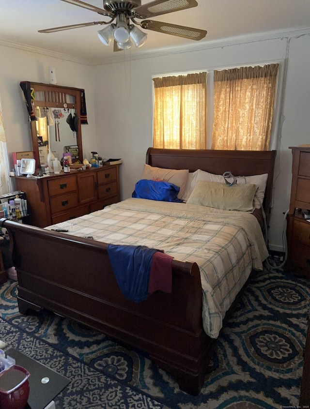 bedroom with ornamental molding and ceiling fan