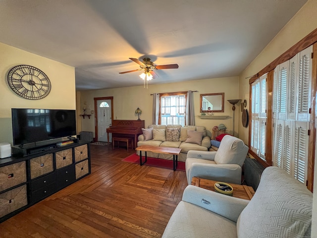 living room featuring dark parquet flooring and ceiling fan