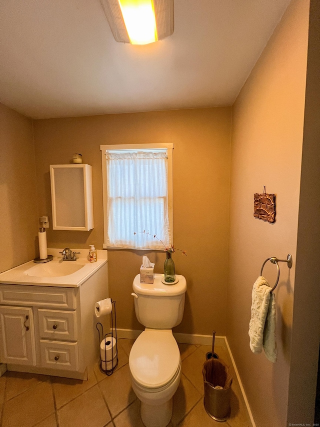 bathroom with vanity, tile patterned flooring, and toilet