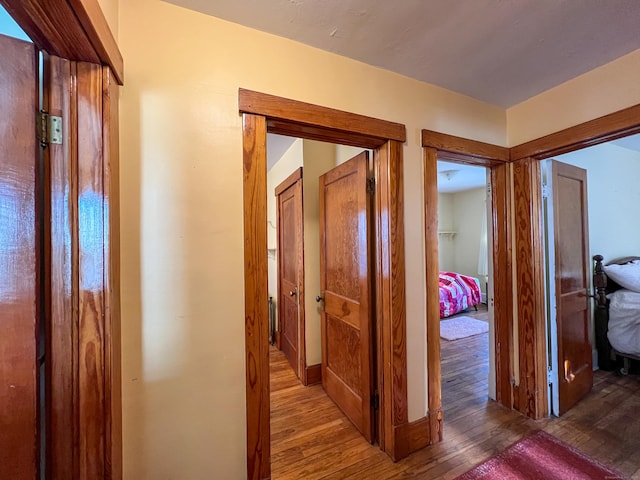 hallway with hardwood / wood-style flooring