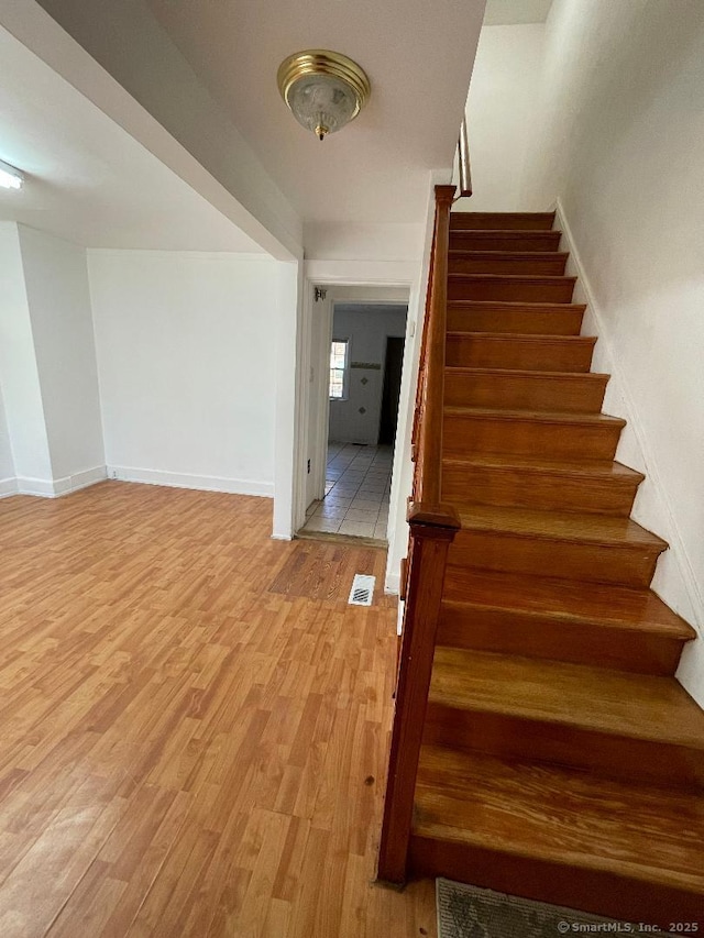 stairs featuring wood-type flooring