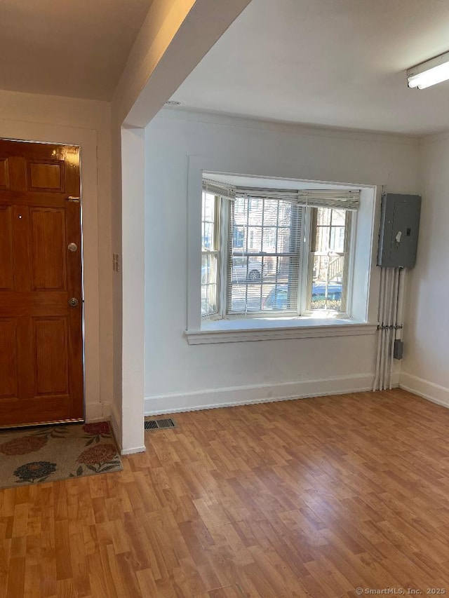 foyer featuring electric panel and light hardwood / wood-style flooring