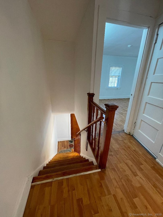 stairs with wood-type flooring