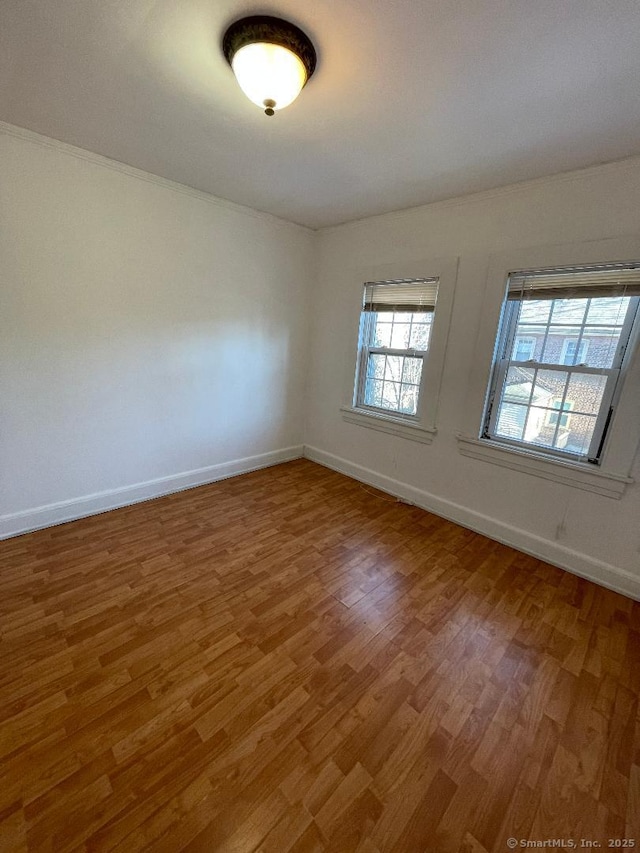 unfurnished room with hardwood / wood-style floors