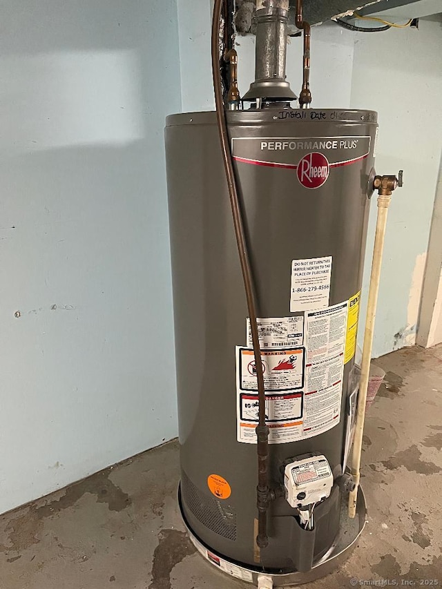 utility room featuring water heater