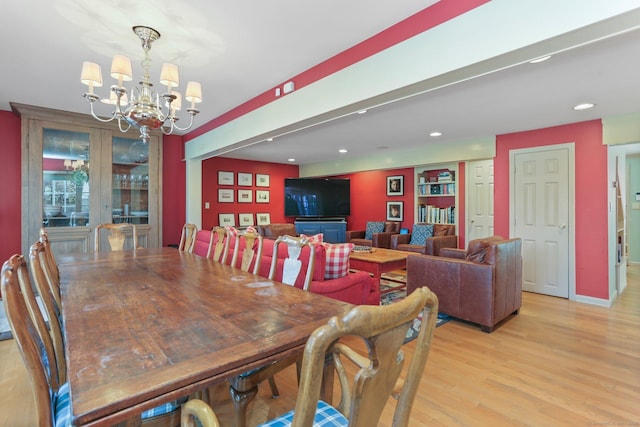 dining space featuring an inviting chandelier and light hardwood / wood-style floors