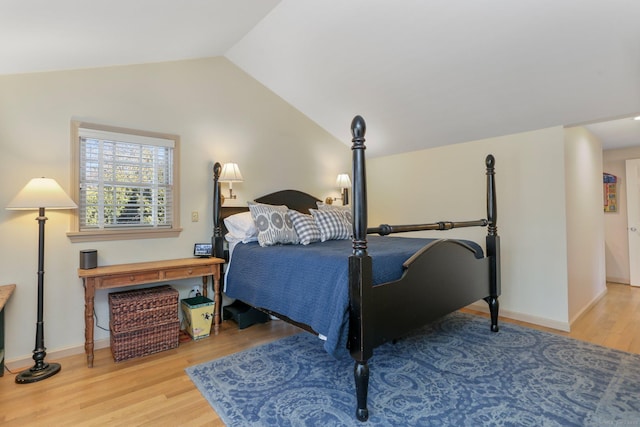 bedroom with hardwood / wood-style flooring and lofted ceiling