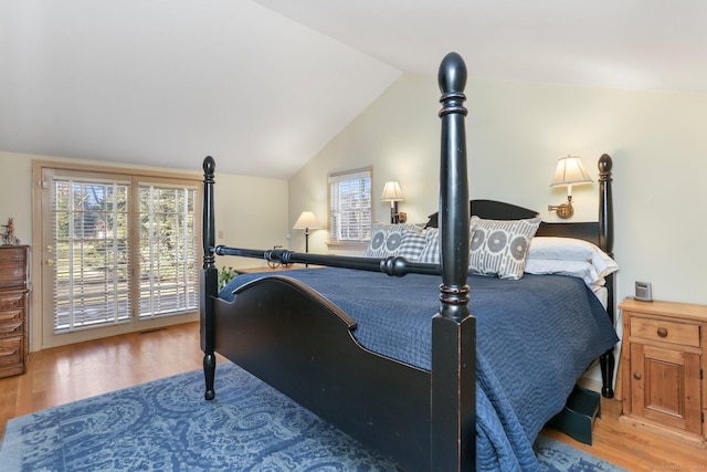 bedroom featuring hardwood / wood-style flooring and vaulted ceiling